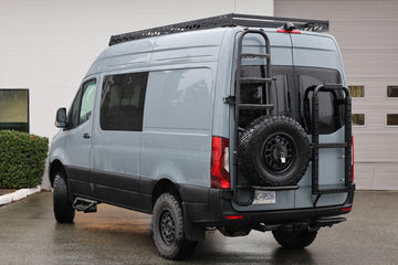 Rear view of a Sprinter with the Tec Vanlife tire and ladder carrier installed
