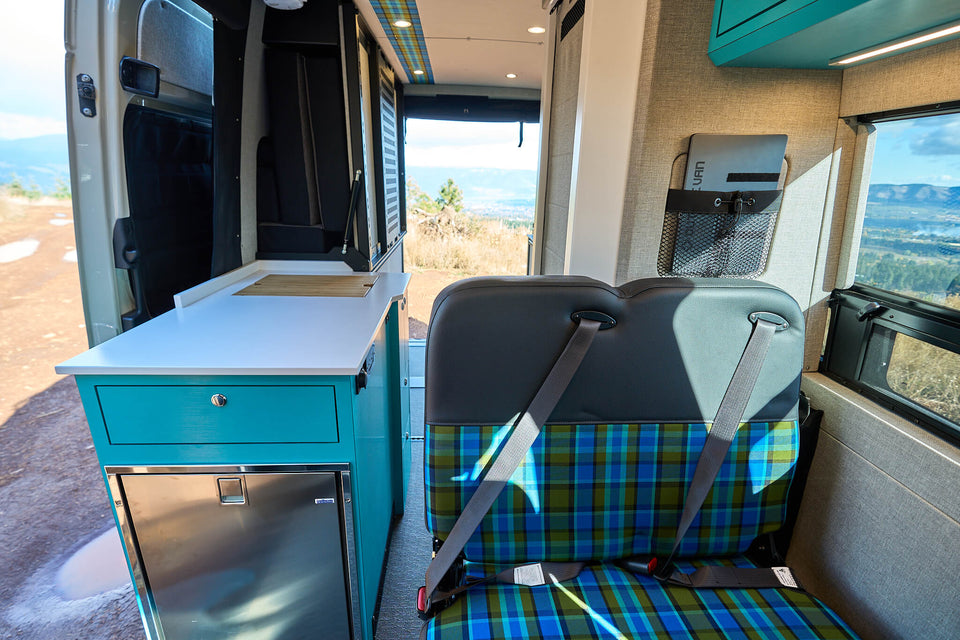 Hidden camper sink installed in a finished van kitchen