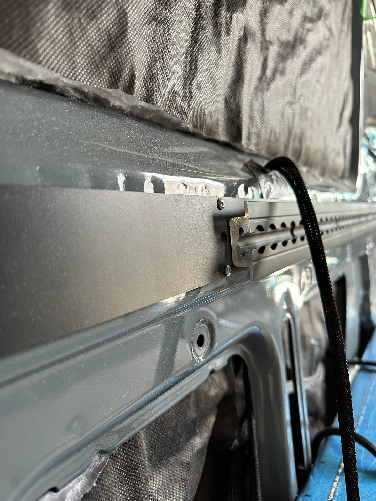 Ford Transit 130 black low-profile L-track package with steel back framing, mounting screws and aluminum end caps